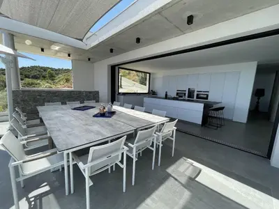 a kitchen and dining room with a table and chairs at Villa Bianca in Zonza