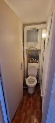 a small bathroom with a toilet with a air conditioner at Maison porticcio vue mer chez Olivier in Grosseto-Prugna