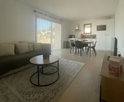 a living room with a couch and a table at T2 Cosy dans le village de Piana in Piana