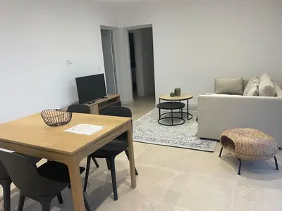 a living room with a table and a couch at T2 Cosy dans le village de Piana in Piana