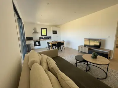 a living room with a couch and a table at T2 Cosy dans le village de Piana in Piana