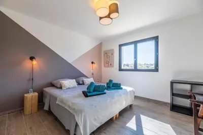 a bedroom with a bed with blue pillows on it at Villa Casa Pietranera in Porto-Vecchio
