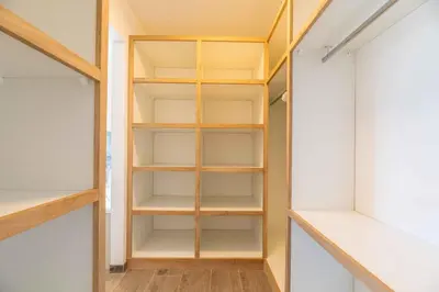 a walk in closet with wooden shelves at Villa Casa Pietranera in Porto-Vecchio