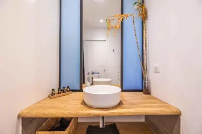 a bathroom with a large white sink on a wooden counter at Villa Casa Pietranera in Porto-Vecchio
