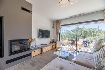 a living room with a couch and a fireplace at Villa Casa Pietranera in Porto-Vecchio