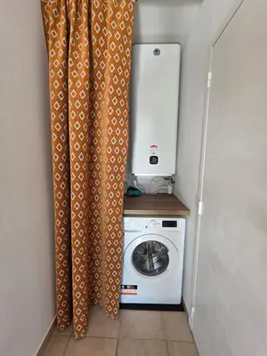 a kitchen with a washing machine in a room at Corsica sea mountain and pool in Santa-Maria-Poggio