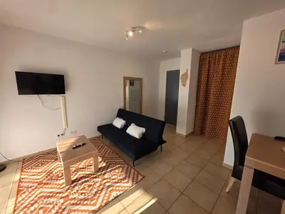 a living room with a couch and a table at Corsica sea mountain and pool in Santa-Maria-Poggio