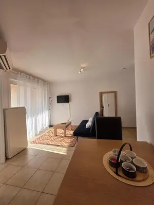a living room with a couch and a table at Corsica sea mountain and pool in Santa-Maria-Poggio