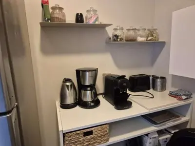 a kitchen counter with a coffee maker on a shelf at U PINU Appartement 3 chambres in Olmeto
