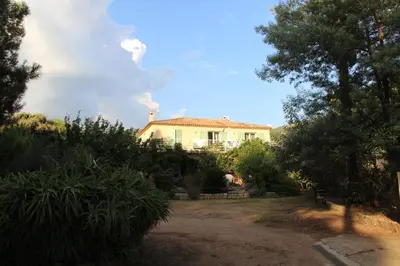 a house with smoke coming out of it at U PINU Appartement 3 chambres in Olmeto