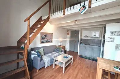 a living room with a couch and a staircase at Central studio in Ajaccio quiet and convenient in Ajaccio