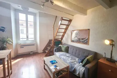 a living room with a couch and a ladder at Central studio in Ajaccio quiet and convenient in Ajaccio