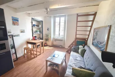 a living room with a couch and a table at Central studio in Ajaccio quiet and convenient in Ajaccio