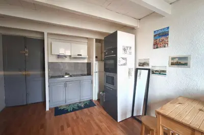 a kitchen with a refrigerator and a sink in it at Central studio in Ajaccio quiet and convenient in Ajaccio