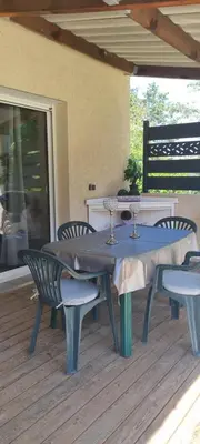 a blue table and chairs on a deck at Maison de vacances en Corse in Prunelli-di-Fiumorbo