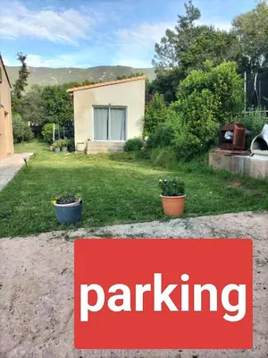 a sign that says parking in front of a yard at Studio avec mezzanine in Cuttoli-Corticchiato