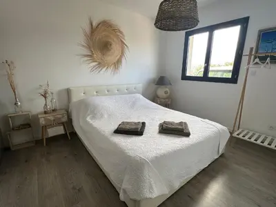 a bedroom with a bed with two towels on it at Proche Porticcio superbe T3 confort moderne au calme belle vue maquis et montagne in Eccica-Suarella