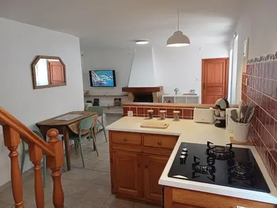 a kitchen with a stove and a counter top at Appartement en duplex au cœur de Piana in Piana