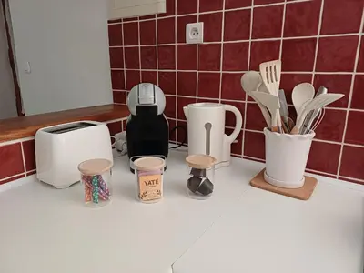 a kitchen counter with utensils and appliances on it at Appartement en duplex au cœur de Piana in Piana