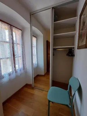 a room with a mirror and a chair in it at Appartement en duplex au cœur de Piana in Piana