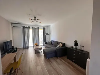 a living room with a couch and a table at Appartement Résidence in Ajaccio
