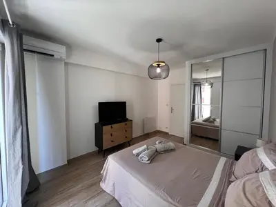 a bedroom with a bed and a mirror and a television at Appartement Résidence in Ajaccio