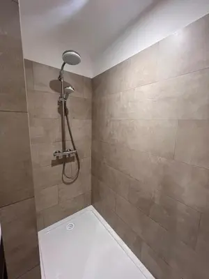a shower with a shower head in a bathroom at Appartement Résidence in Ajaccio