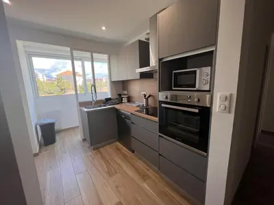 a kitchen with stainless steel appliances and a window at Appartement Résidence in Ajaccio