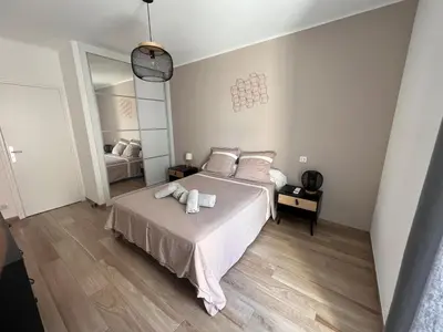 a bedroom with a bed with two towels on it at Appartement Résidence in Ajaccio