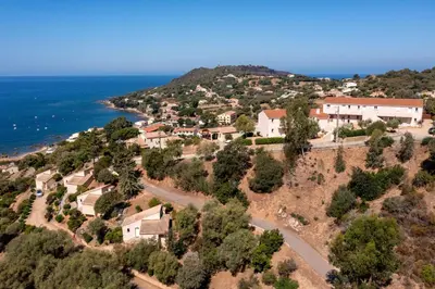 an aerial view of a village on a hill next to the ocean at Résidence Roc e Mare in Tiuccia