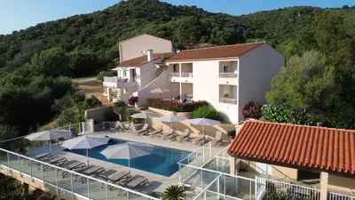 a villa with a swimming pool and a house at Résidence Roc e Mare in Tiuccia