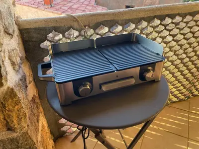 a toaster oven sitting on a table next to a wall at Casa Padume - Maison de village en Balagne in Nessa