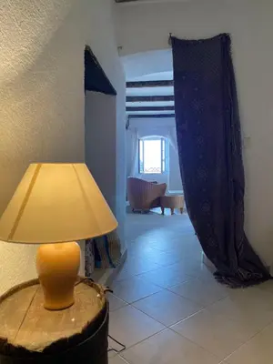 a lamp sitting on a table in a room at Casa Padume - Maison de village en Balagne in Nessa