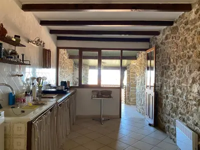 a kitchen with a sink and a counter top at Casa Padume - Maison de village en Balagne in Nessa