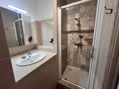 a bathroom with a sink and a shower at ST CYPRIEN A6 5 pers à 250m de la plage de sable Saint Cyprien in Lecci
