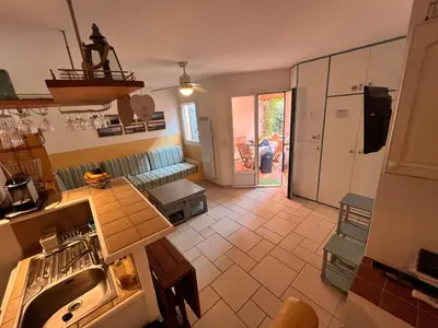 a kitchen with a sink and a living room at ST CYPRIEN A6 5 pers à 250m de la plage de sable Saint Cyprien in Lecci