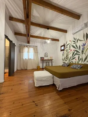 a bedroom with a bed and a table in it at Ferme auberge U sapè fà in Saliceto