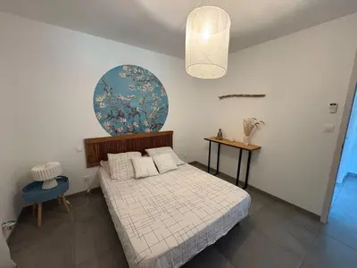 a bedroom with a bed and a blue and white at Bas de villa 80m2 secteur Ajaccio in Tavaco