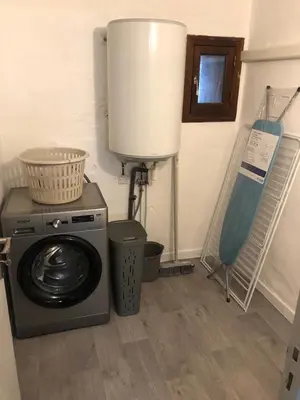 a laundry room with a washing machine and a window at T3 en duplex au cœur de Piana in Piana
