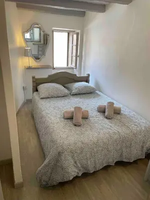 a bedroom with a bed with two pillows on it at T3 en duplex au cœur de Piana in Piana