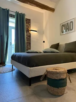 a bedroom with a bed in a room at Demeure de charme, appartement du Campu di l altru mondu in San-Giuliano