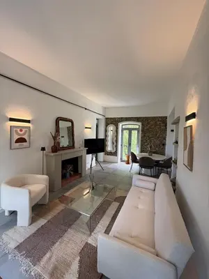 a living room with a couch and a table at Demeure de charme, appartement du Campu di l altru mondu in San-Giuliano
