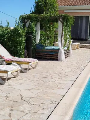 a living room with a couch and a kitchen at studio piscine en Haute Corse in Venzolasca