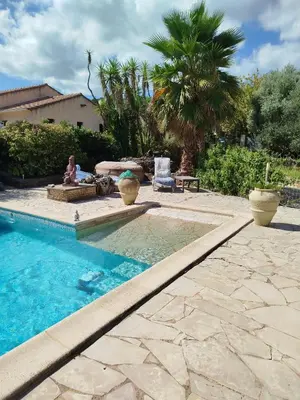 a backyard with a swimming pool and a gazebo at studio piscine en Haute Corse in Venzolasca