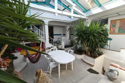 a kitchen with white cabinets and a refrigerator at Spacious villa with pool and sea views in Villanova