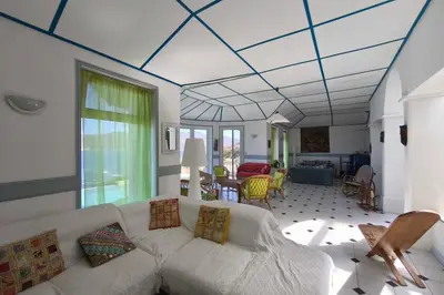 a living room with a bed and a couch at Spacious villa with pool and sea views in Villanova