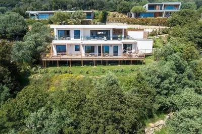 an aerial view of a house on a hill with trees at Villa Lalie in Olmeto