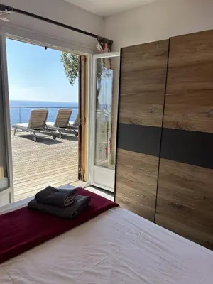 a bedroom with a bed and a view of the ocean at La Colline by Pinarello Villa Services in Fautea