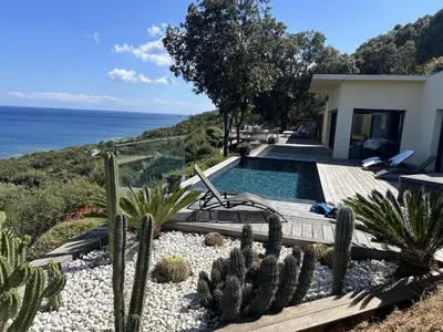 a house with a swimming pool and cactus at La Colline by Pinarello Villa Services in Fautea