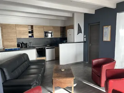 a kitchen and living room with a couch and a table at La Colline by Pinarello Villa Services in Fautea